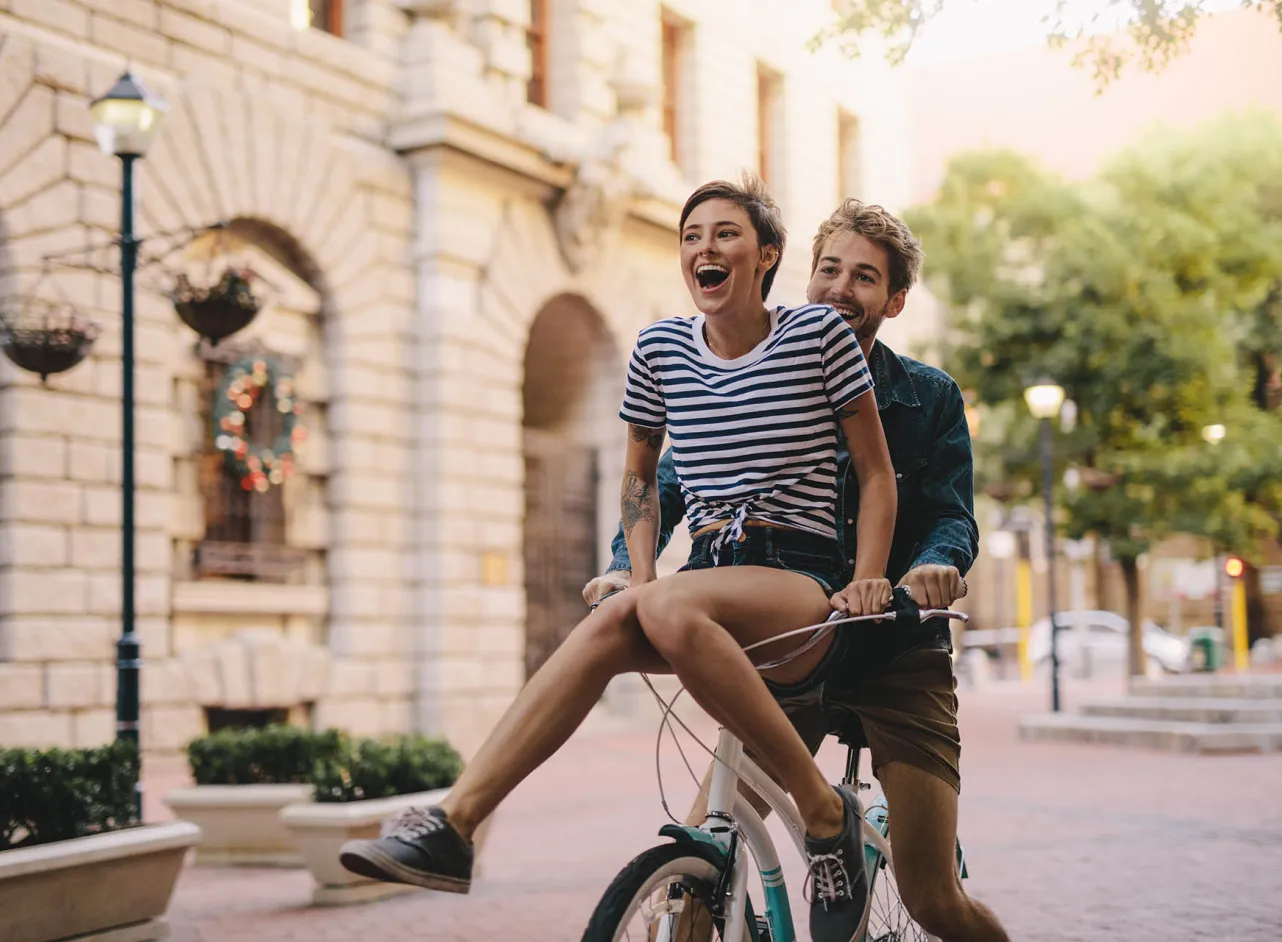 smiling couple on a bicycle